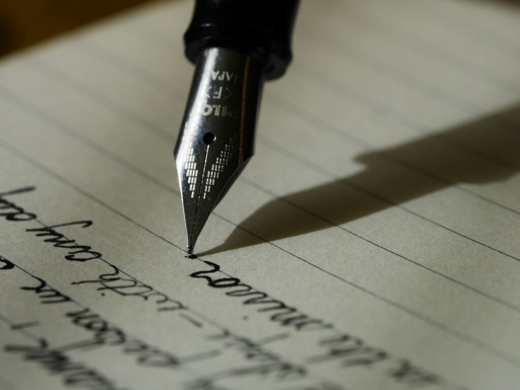 a pen writing an old fashioned letter